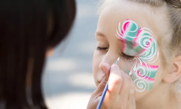 Criança com pintura facial feita no Mini & Magic